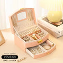 Porta-Jóias Maleta Compacto e Leve com alça de transporte, ideal para organizar e proteger suas joias em viagens. Design elegante e material de couro PU. Cabe facilmente em bolsas de mão